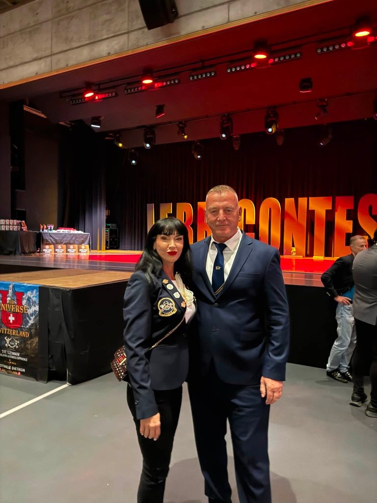 A woman and a man from the delegation in front of the competition stage in Zurich.