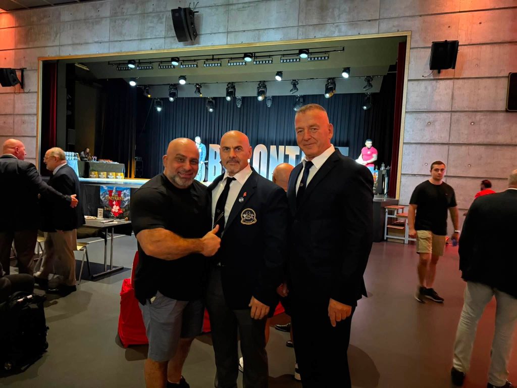 Three men next to the competition stage in Zurich.