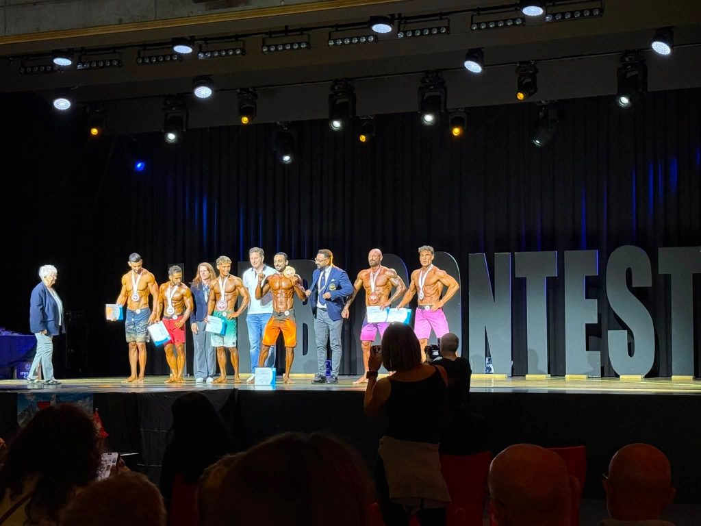 Athletes with medals on stage at Mr. Universe Switzerland 2026.